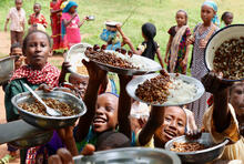 children holding plates with food